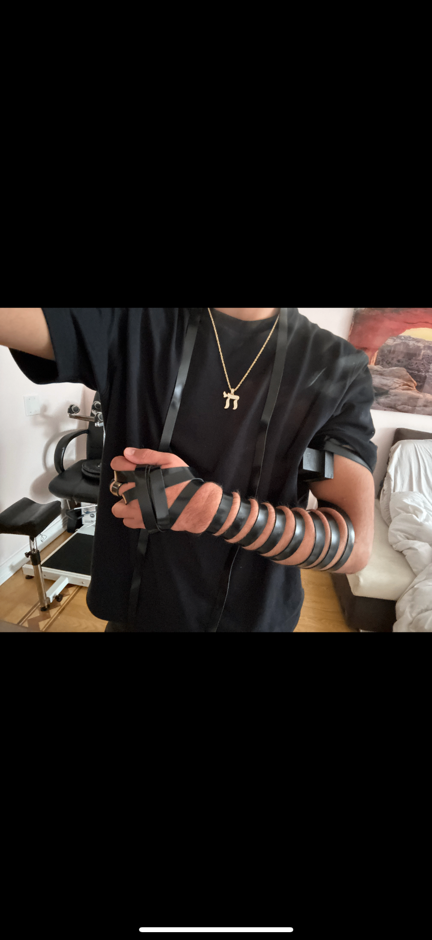 Person wearing tefillin with Chai necklace